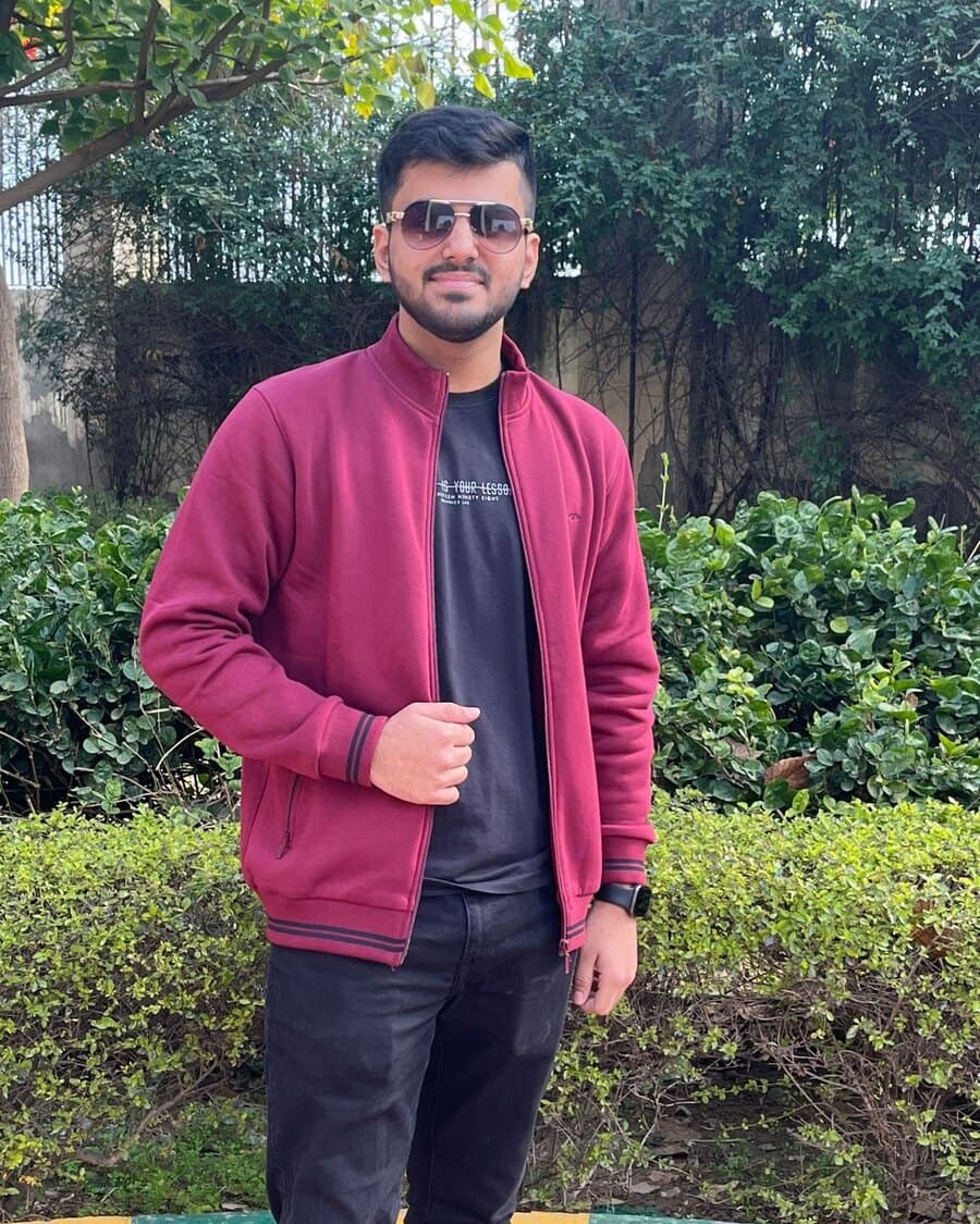 Kush Ahuja, AI engineer, in a crimson jacket